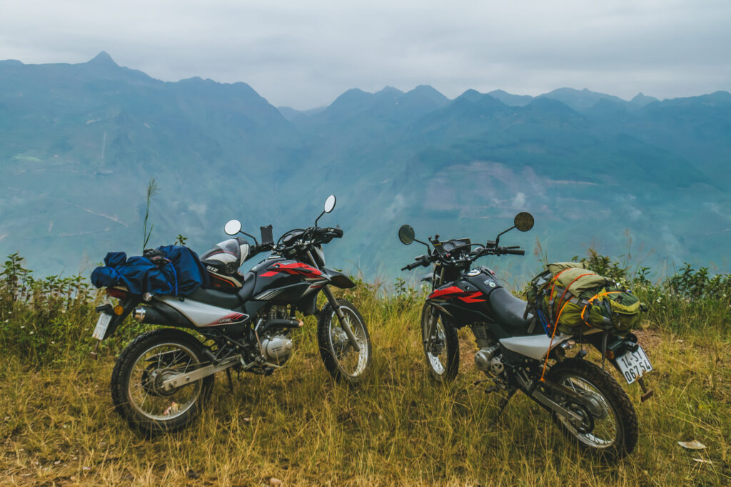 A road between rice paddies in North Vietnam with mountains in the background