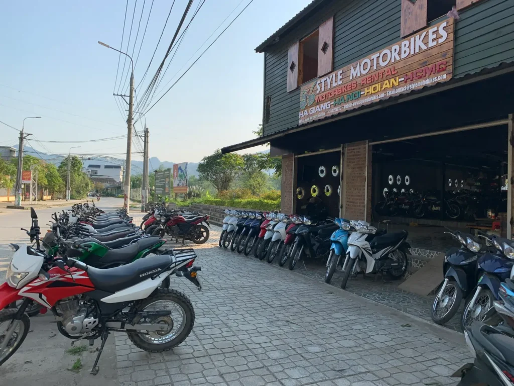 large range of motorbikes outside the ha giang shop offering different options for ha giang loop bike rental
