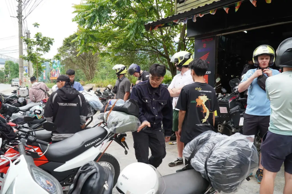 staff in ha giang showing customers the bikes and preparing them for the tour